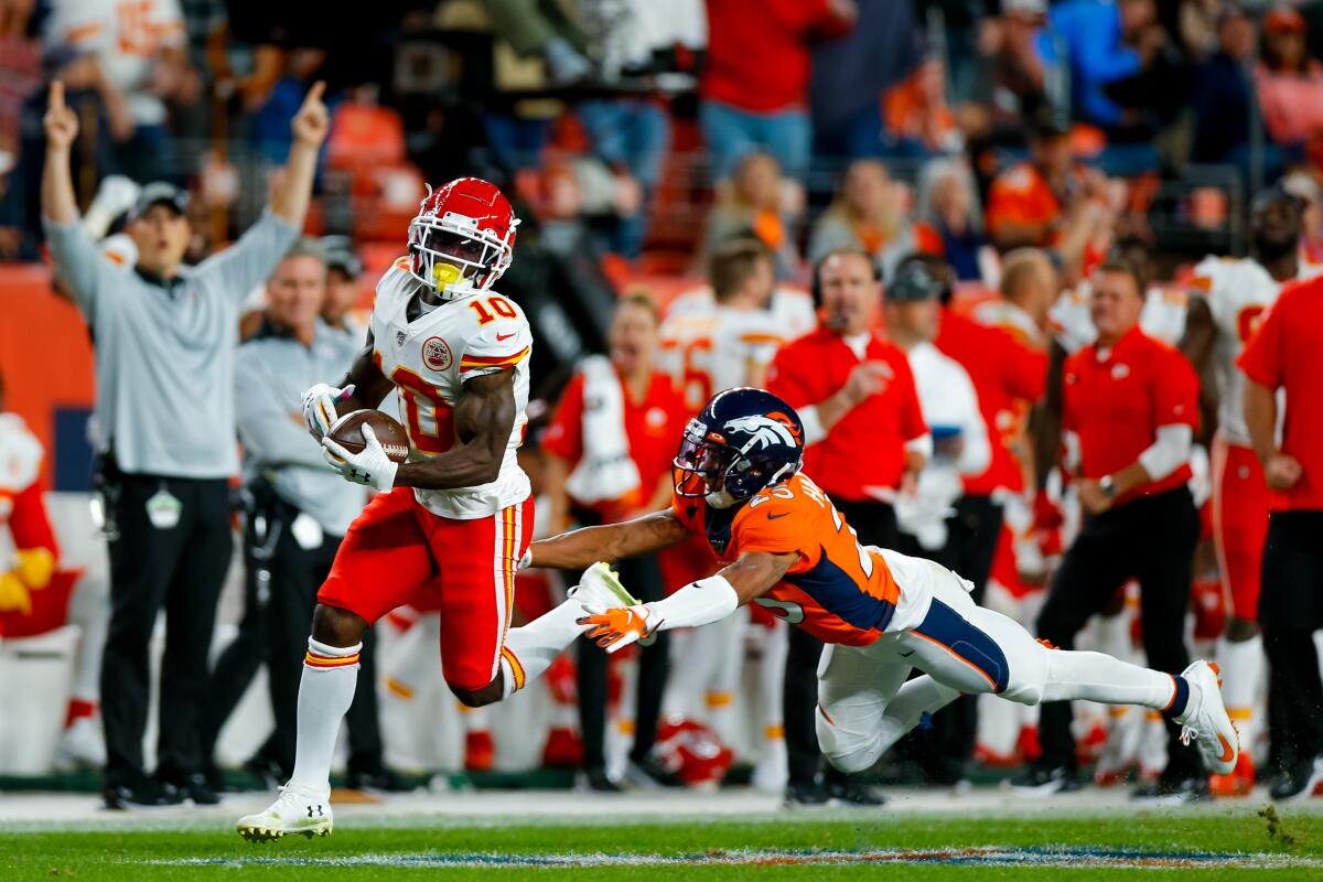 Kansas City wide receiver Tyreek Hill catches a touchdown pass ahead of Denver Broncos cornerback Chris Harris Jr.