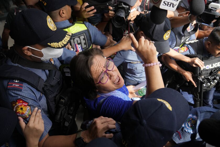 FILE - Detained ex-senator Leila de Lima reacts as she goes out of the Muntinlupa trial court to attend her trial on May 12, 2023 in Muntinlupa, Philippines. A Philippine court rejected on Wednesday June 7, 2023 a bail petition by a former Filipino senator and top human rights enforcer, who opposed then President Rodrigo Duterte's deadly anti-drugs crackdown but was instead accused by his administration of drug dealing and locked up in jail more than six years ago. (AP Photo/Aaron Favila, File)