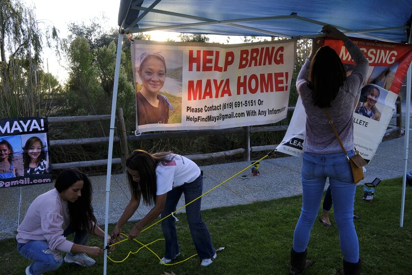 |Maya Millete supporters put up banners before a candlelight vigil for her Friday night.|Friends and family of May "Maya" Millete gathered at San Miguel Park in Chula Vista near sunset Friday for a candlelight vigil. Her husband Larry Millette was arrested earlier this week in her murder and is being held without bail.