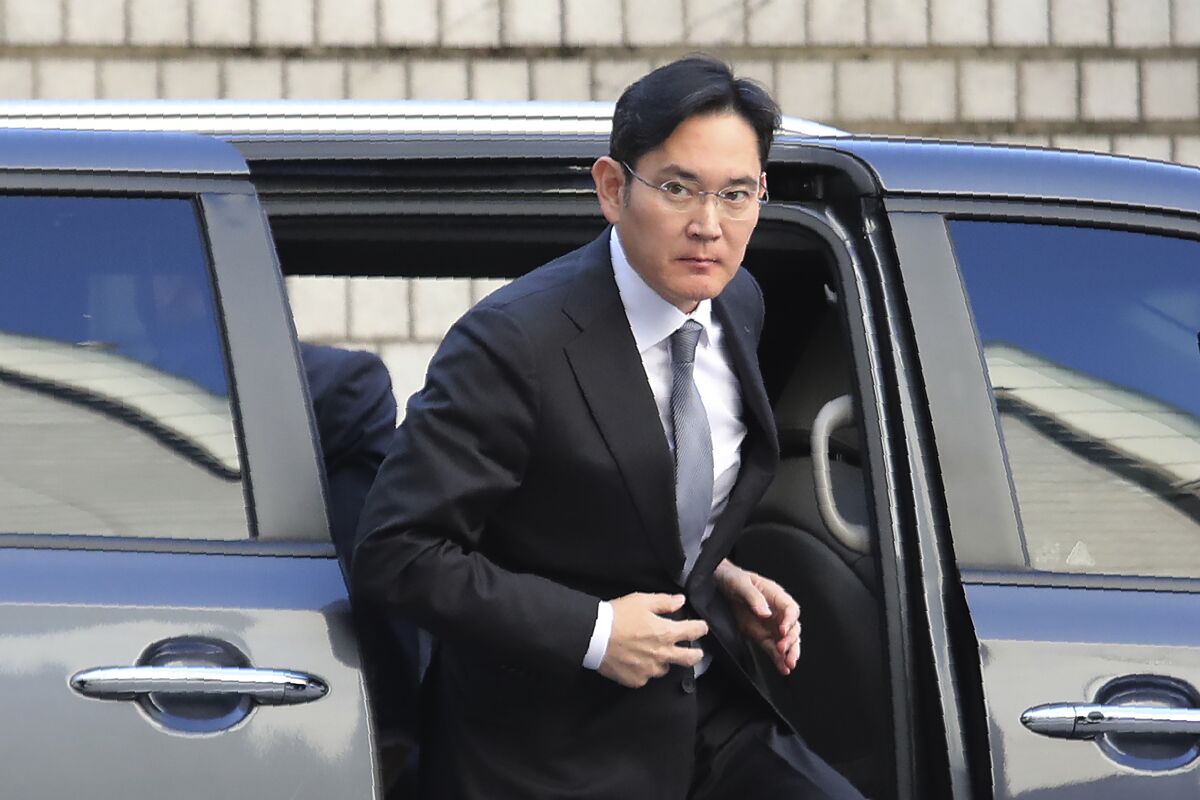 FILE - In this Nov. 22, 2019, file photo, Samsung Electronics Vice Chairman Lee Jae-yong gets out of a car at the Seoul High Court in Seoul, South Korea. In an announcement by Seoul’s Justice Ministry on Monday, Aug. 9, 2021, South Korea will release billionaire Lee on parole this week after he spent 18 months in prison for his role in a massive corruption scandal that triggered nationwide protests and ousted the country’s previous president. (AP Photo/Ahn Young-joon, File)