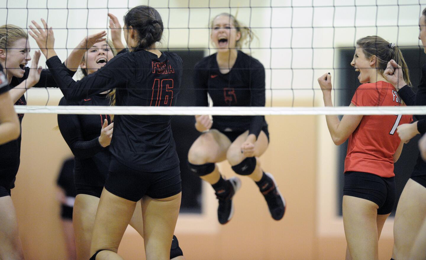 The Flintridge Sacred Heart Academy girls' volleyball team celebrates a point against San Clemente during a CIF playoff match on Tuesday, Oct. 10, 2015.