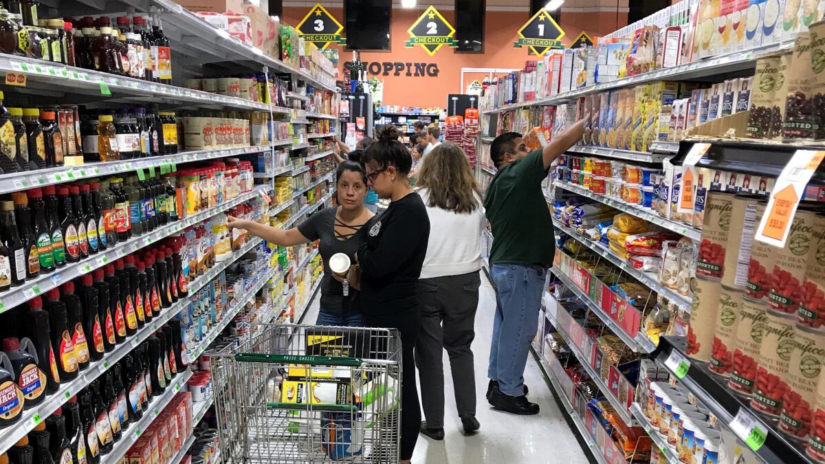 Shoppers browse the aisles at Price Choice Supermarket in Miami.