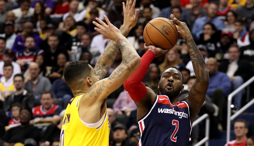 Wizards guard John Wall goes for 40 points against Kyle Kuzma and the Lakers on Sunday.