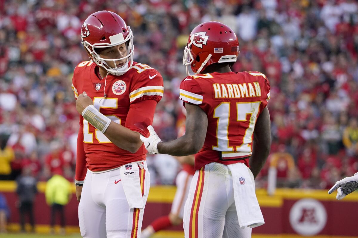 Kansas City Chiefs quarterback Patrick Mahomes, left, talks with wide receiver Mecole Hardman (17) during the first half of an NFL football game against the Green Bay Packers Sunday, Nov. 7, 2021, in Kansas City, Mo. (AP Photo/Ed Zurga)