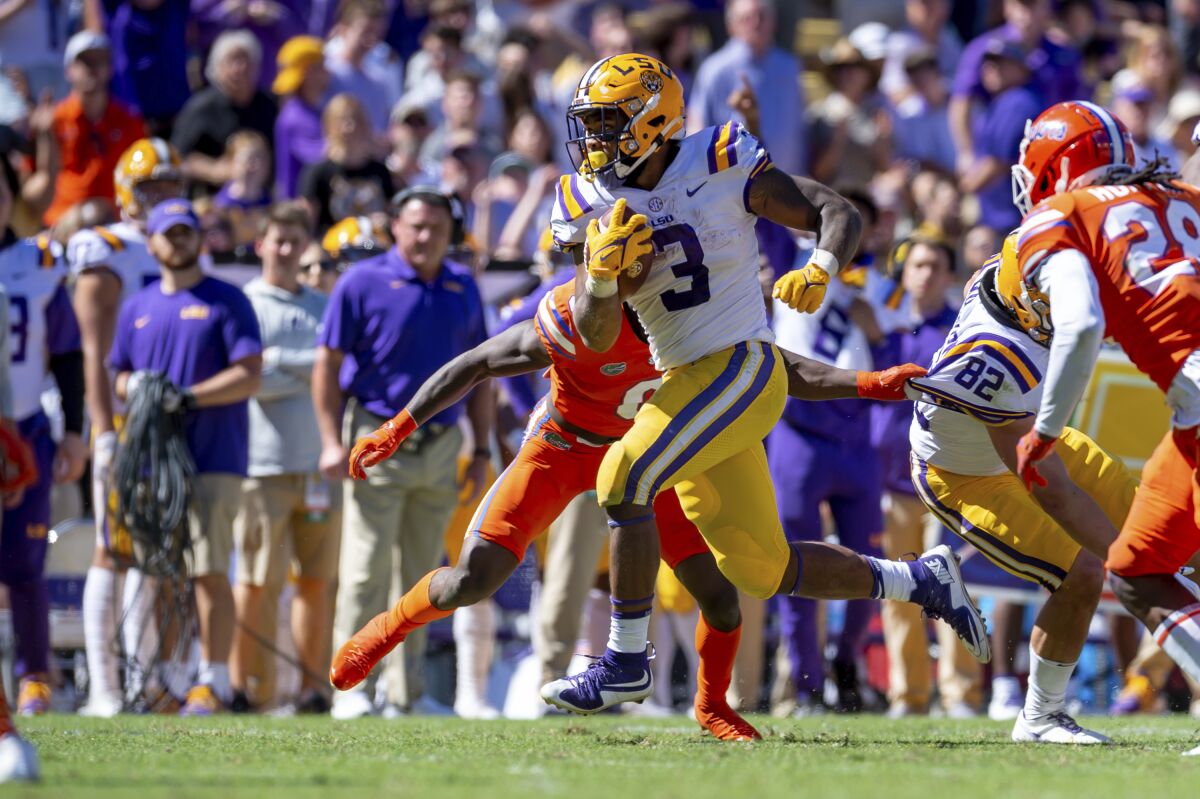 LSU's Tyrion Davis-Price runs the ball against Florida during an NCAA college football game, Saturday, Oct. 16, 2021, Baton Rouge, La. (Scott Clause/The Daily Advertiser via AP)