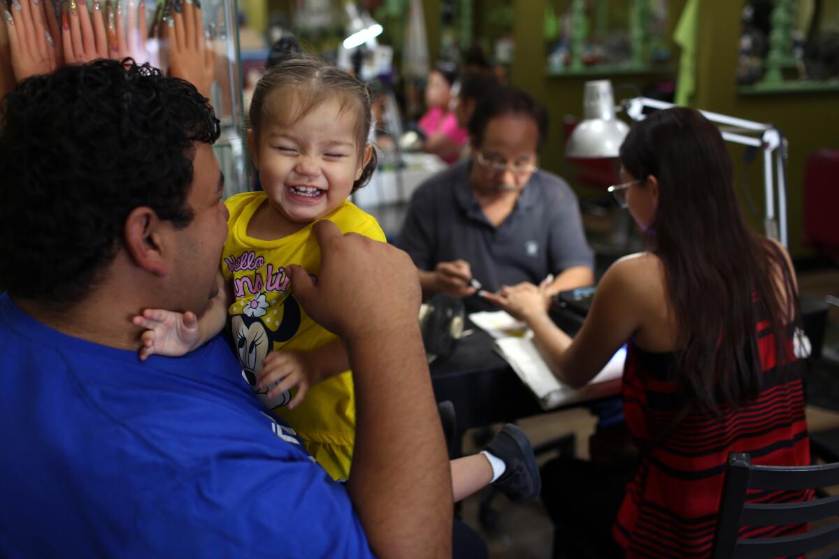 Jesus Puga laughs with his daughter Anna-Marie Puga