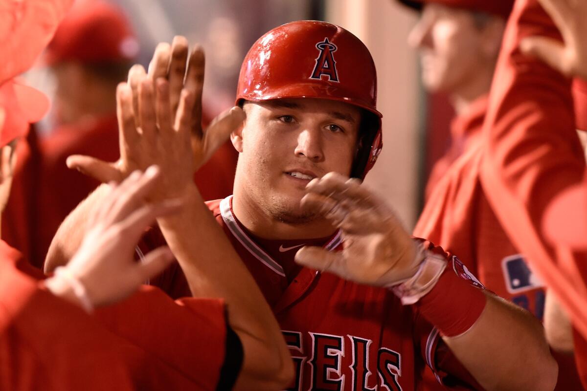 Angels' Mike Trout is congratulated after scoring against Baltimore on May 20.