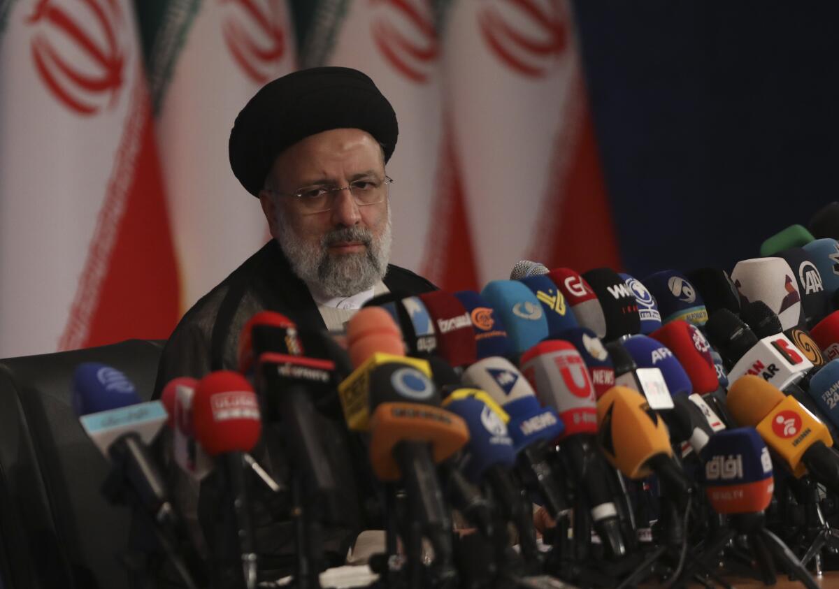 Iran's new president-elect, Ebrahim Raisi speaks in front of several microphones