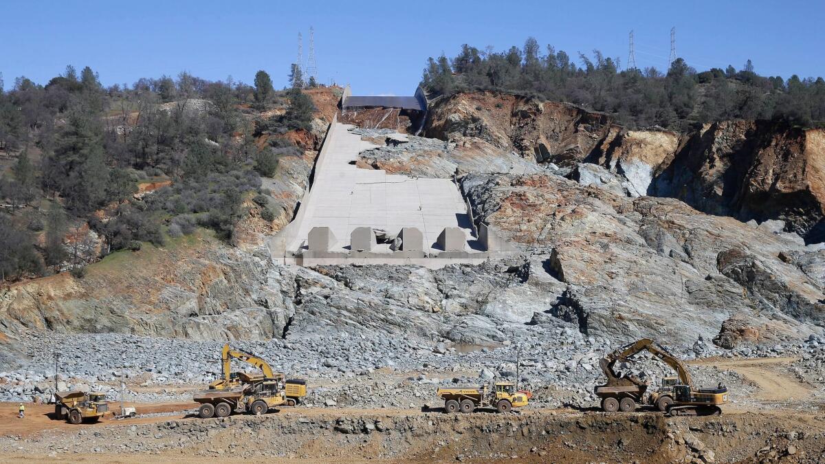 Construction crews clear rocks away from Oroville Dam's crippled spillway Feb. 28, 2017. California water authorities stopped the flow of water down the spillway Monday, allowing workers to begin clearing out massive debris that's blocking a hydroelectric plant from operating.