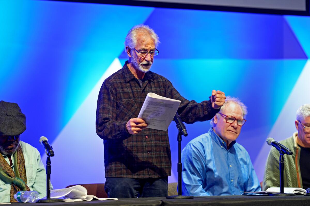 David Strathairn (standing) plays Dr. Stockmann in Ibsen’s "An Enemy of the People" at the National Academy of Sciences.