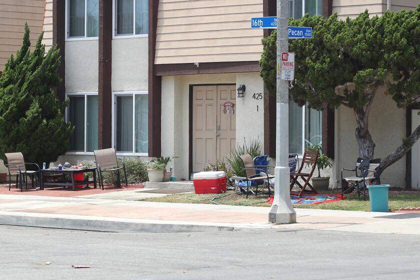 Beach chairs, a cooler, and tables rest at the corner of 16th St. and Pecan where the HBPD is investigating a stabbing attack that killed two people and injured three others that occurred at the corner of the multifamily residential complex in Huntington Beach.