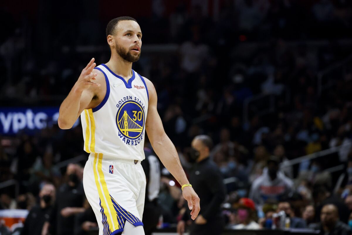 Golden State Warriors guard Stephen Curry reacts after making a basket in the second half against the Clippers.