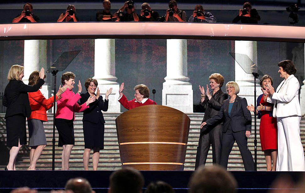 Female members of the U.S. Senate gather onstage.