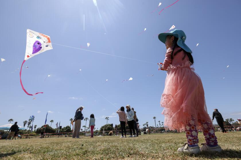 SAN DIEGO, CA - MAY 15, 2024: Four-year-old Summer Sha flies her first kite during the 77th annual Ocean Beach Kite Festival at Robb Field in San Diego on Saturday, May 18, 2024.
