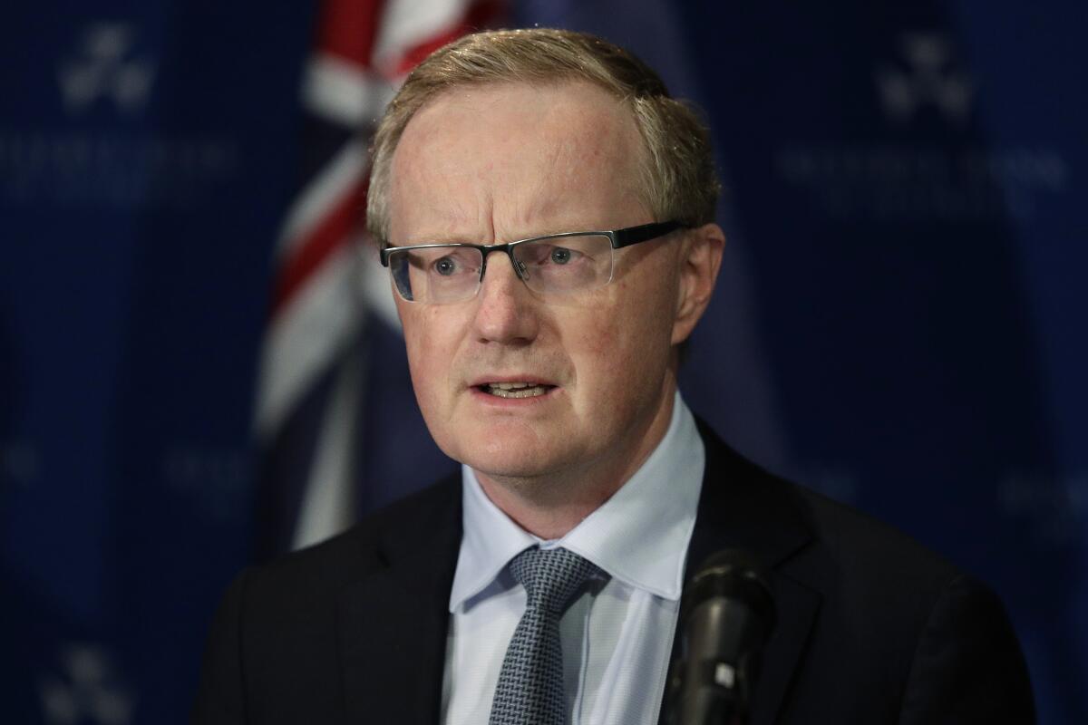 FILE - Australia's Reserve Bank Governor Philip Lowe speaks in Sydney, March 19, 2020. Lowe said on Tuesday, Nov. 16, 2021, the nation's benchmark interest rate could remain at record lows until 2024 despite the pandemic-induced global inflation shock. (AP Photo/Rick Rycroft, File)