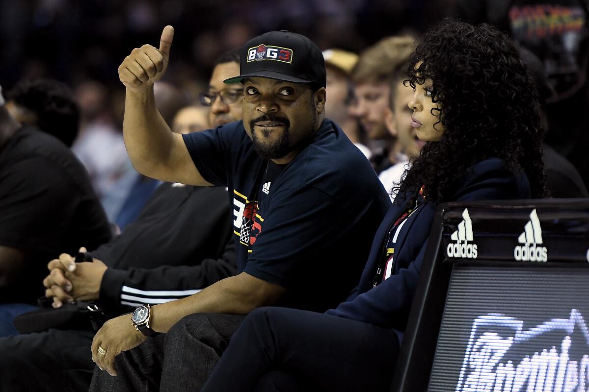 Ice Cube and wife Kimberly Woodruff look on during a Big3 three-on-three basketball league game on Aug. 3 in Chicago.