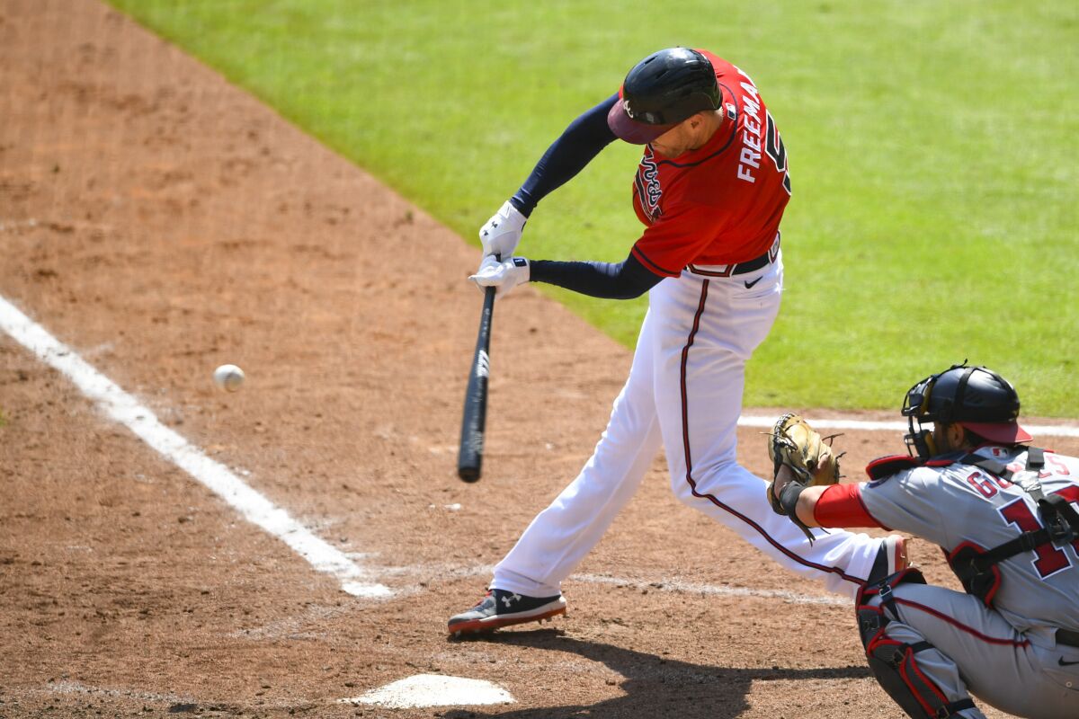 Atlanta Braves' Freddie Freeman connects for a grand slam over left center field during the sixth inning of a baseball game against the Washington Nationals, Sunday, Sept. 6, 2020, in Atlanta. (AP Photo/John Amis)