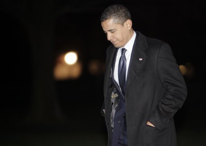 President Barack Obama arrives on the South Lawn of the White House on Wednesday, April 8, 2009 in Washington after returning from an eight-day European trip and a five-hour visit to the Iraq war zone. (AP Photo/Evan Vucci)