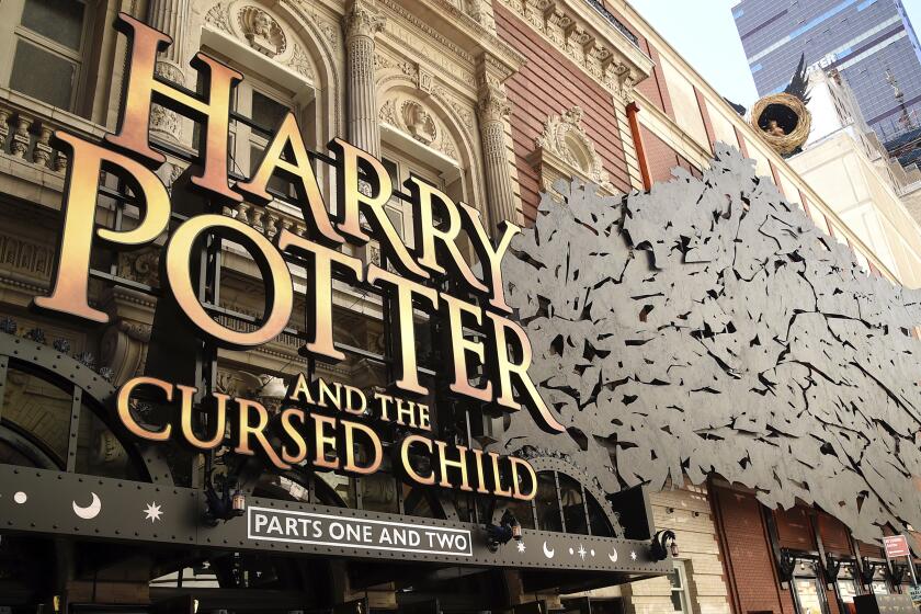 A sign for "Harry Potter and the Cursed Child" outside a theater