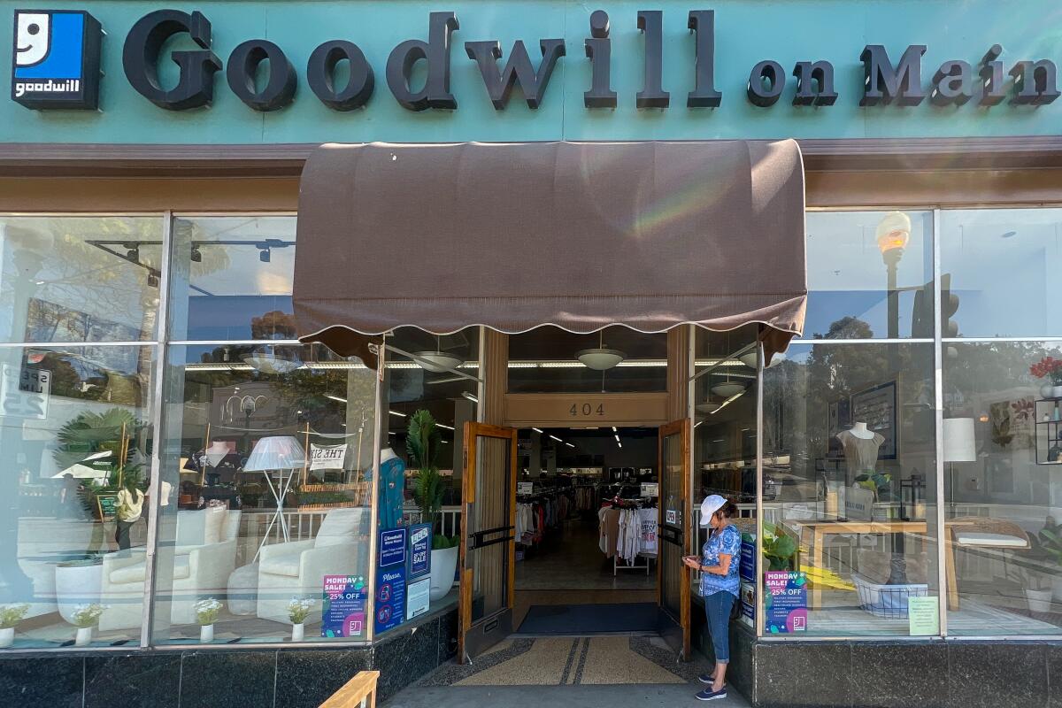 The front entrance to Goodwill on Main, with glass display cases on either side of the door.