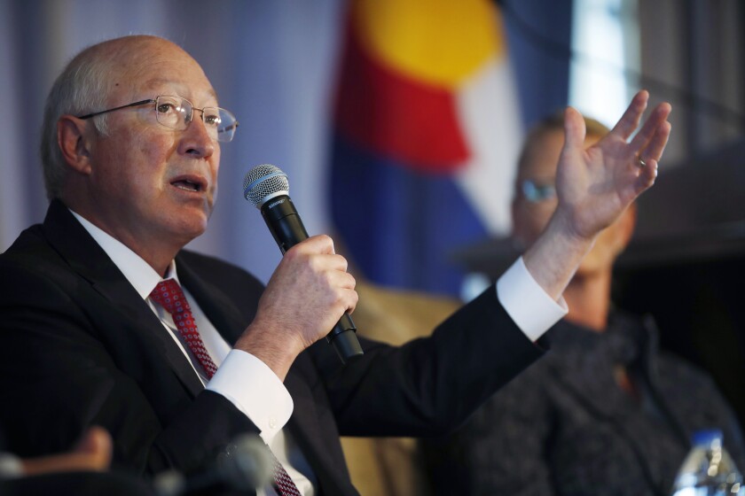 Ken Salazar speaks into a microphone at an energy luncheon in 2018.