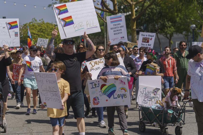 FILE - Supporters of gay, lesbian, drag, queer, and transgender rights attend a rally during an Easter Sunday Drag March in protest of anti-LGBTQ legislation nationwide, in West Hollywood, Calif., on Sunday, April 9, 2023. On Friday, Sept. 22, 2023, California Gov. Gavin Newsom announced his veto of a bill that would have required judges to consider whether a parent affirms their child's gender identity when making custody and visitation decisions. (AP Photo/Damian Dovarganes, File)
