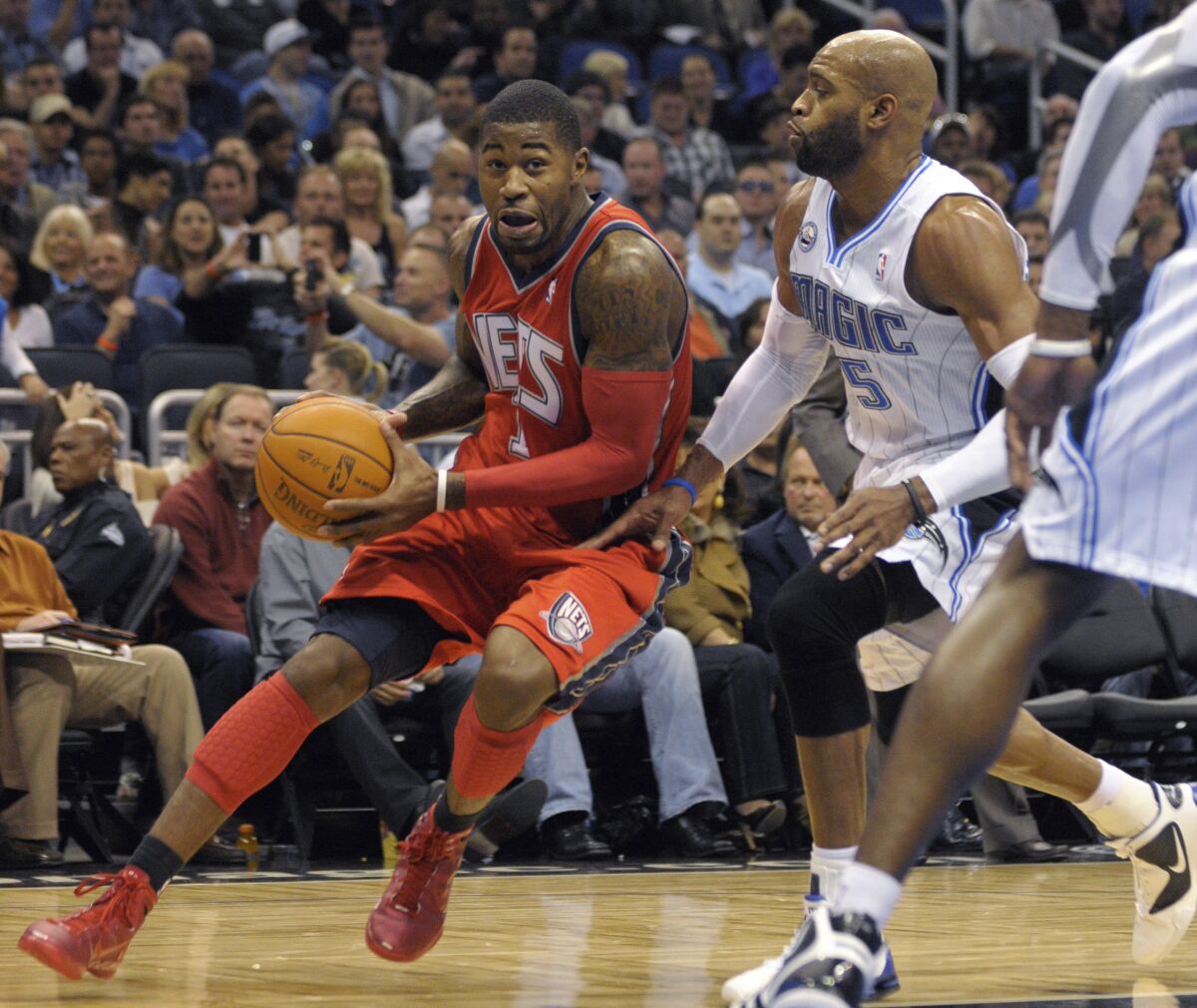 Two professional basketball players compete on court.