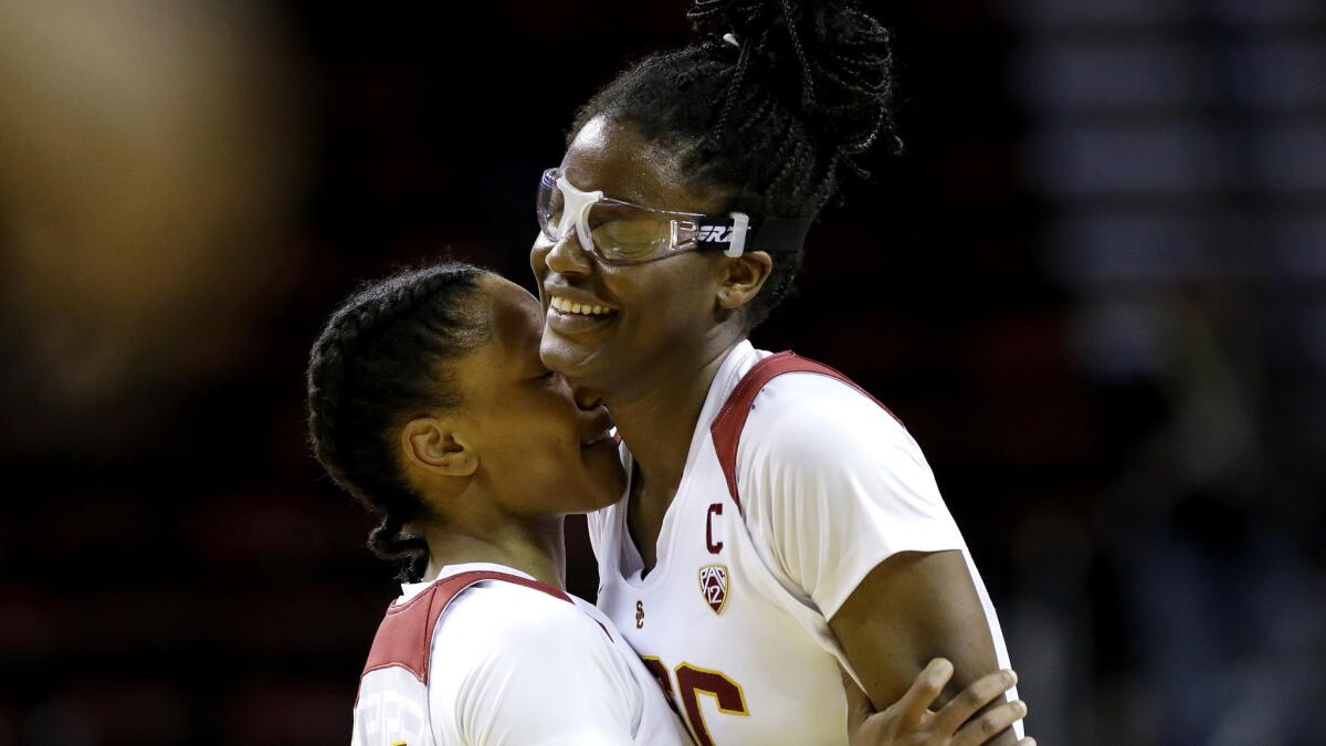 USC forward Temi Fagbenie, right, is embraced by guard Sadie Edwards in the final moments of a victory over Washington State on Thursday night in Seattle.