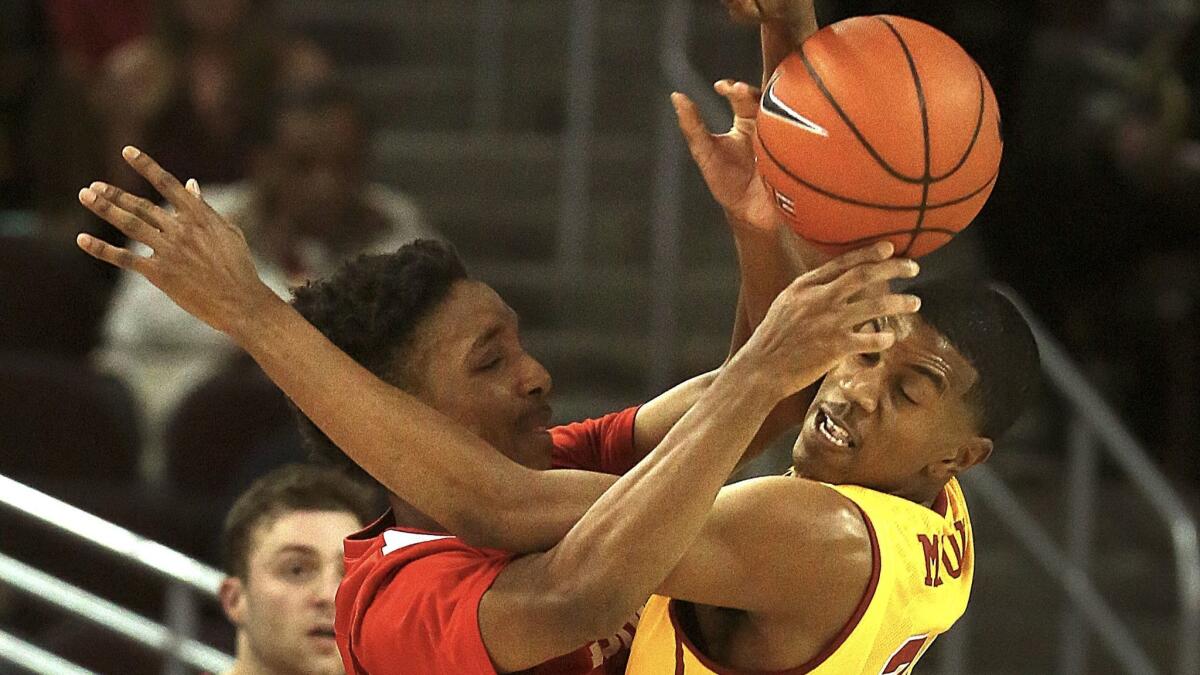 Trojans De'Anthony Melton tangles with Matt Morgan of the Cornell Big Red at the Galen Center on Monday evening.