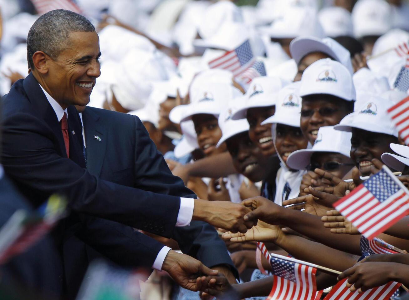 U.S. President Barack Obama greets Tanzanians at an official arrival ceremony in Dar Es Salaam