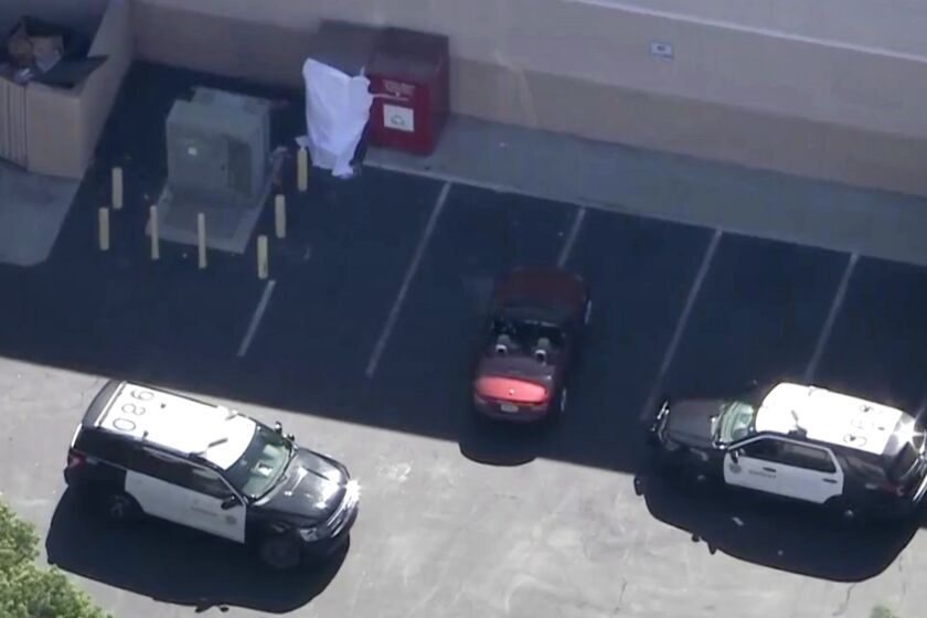 A woman’s body was found partially in a donation box (upper left) in Santa Clarita Thursday morning,