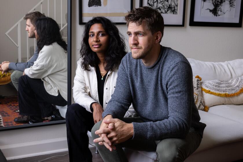 Los Angeles, CA - May 20: Nikeeta Sriram, left, and Peter Banachowsk, right, rented their home to a man named Nicholas Jarzabek, who then immediately turned around and started renting it on Airbnb, which was not allowed in the lease. They've been fighting Airbnb to stop guests from entering the home, and they've also been fighting to evict Jarzabek. Photographed at home (not the Airbnb rental) in Name of Location on Monday, May 20, 2024 in Los Angeles, CA. (Brian van der Brug / Los Angeles Times)