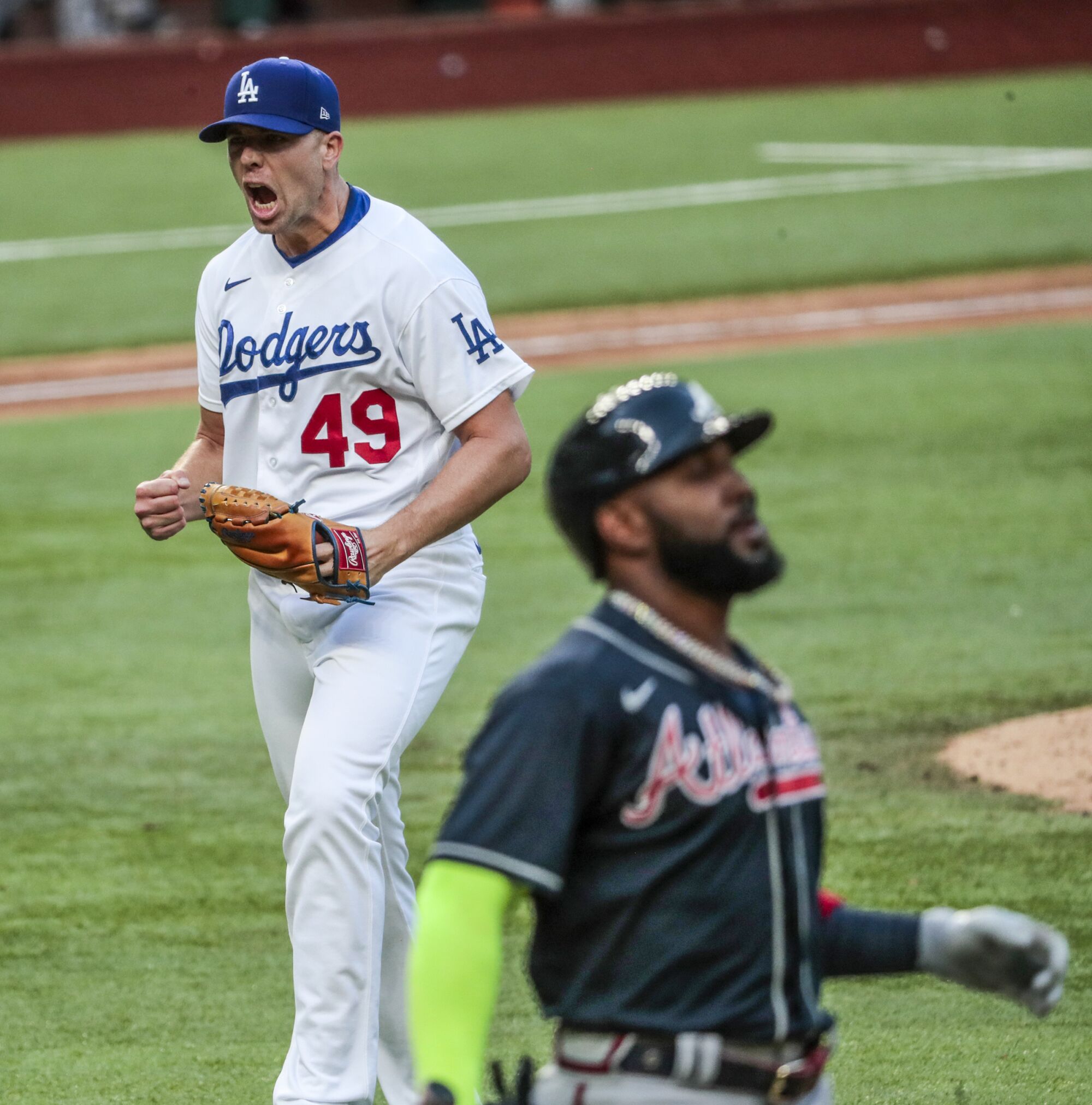 Dodgers reliever Blake Treinen celebrates after getting Atlanta's Marcell Ozuna, right, to fly out in the seventh inning.