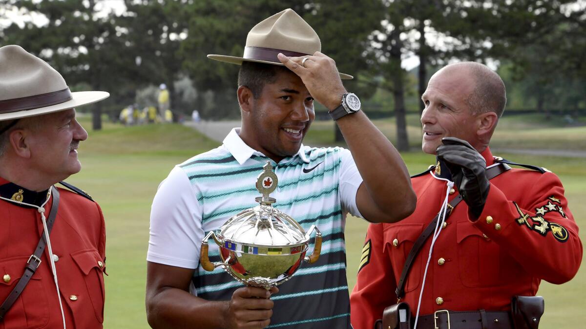 Jhonattan Vegas tries on a mountie's hat during the awards ceremony at the Canadian Open on Sunday.