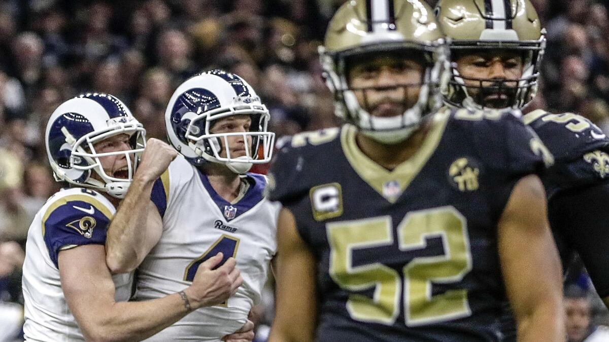 Rams kicker Greg Zuerlein is embraced by punter Johnny Hekker after hitting a 57-yard field goal in overtime to defeat the Saints 26-23 in the NFC Championship at the Superdome on Jan 20, 2019.