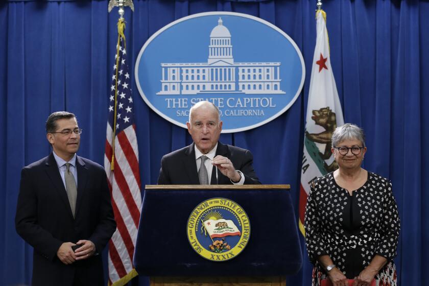 Gov. Jerry Brown, flanked by California Attorney General Xavier Becerra, left, and California Air Resources Board Chair Mary Nichols, discusses a lawsuit filed by 17 states and the District of Columbia over the Trump administration's plans to scrap vehicle emission standards during a news conference Tuesday, May 1, 2018, in Sacramento, Calif. The U.S. Environmental Protection Agency has moved to roll back tailpipe emissions standards for vehicles manufactured between 2022 and 2025. (AP Photo/Rich Pedroncelli)