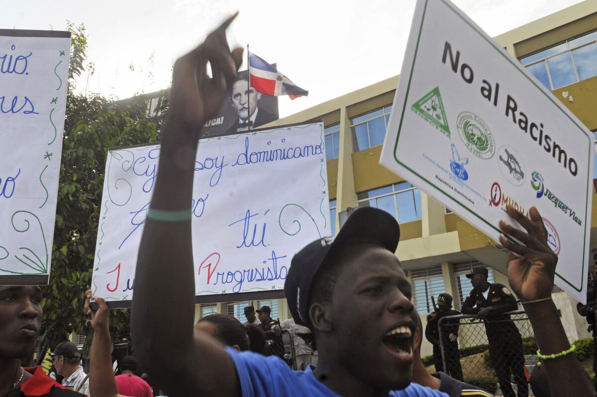Dominicans of Haitian descent protest outside the Constitutional Court in Santo Domingo, Dominican Republic after the court decided to strip Dominican citizenship from the children of Haitian migrants.