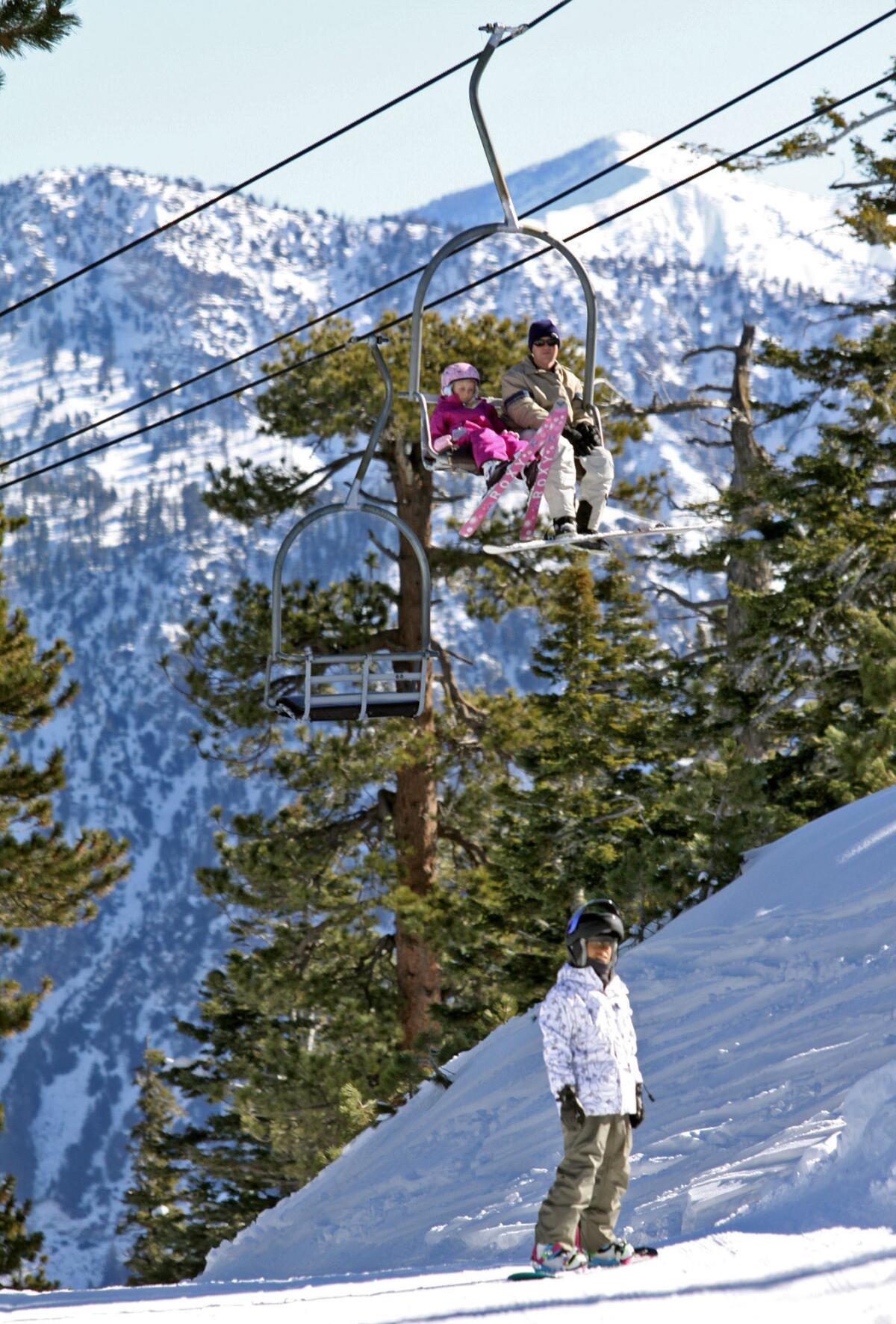 FILE PHOTO: Snowboarder Brian Bello, 35 of North Hollywood, waits for some friends near lift #2 at Mt. Waterman Ski Area in the Angeles National Forest on Saturday, January 8, 2011. After two dry winter seasons, the owners of Mt. Waterman expect to open their small mountain resort to cyclists in July 2013.