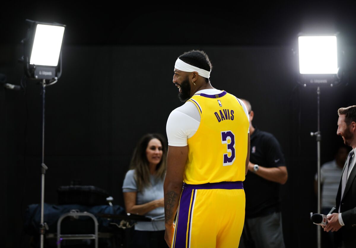 Anthony Davis stands in the spotlight during an interview on media day.