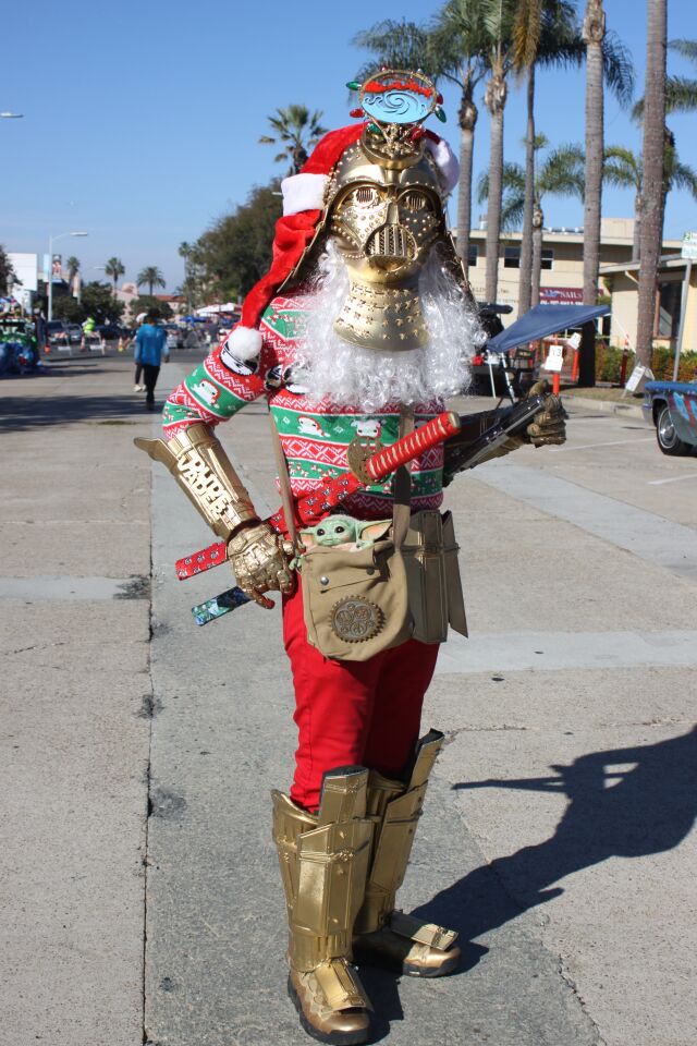 "Dude Vader" greets La Jolla Christmas Parade visitors in his "Star Wars" holiday finest.