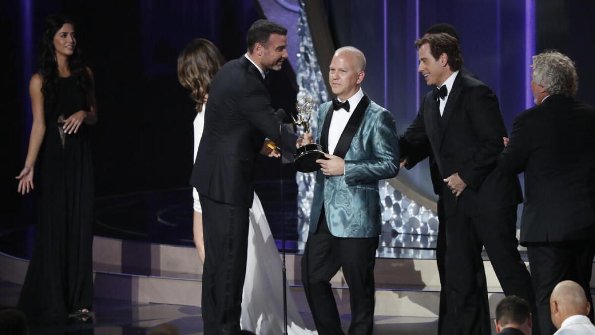 Ryan Murphy, left, and John Travolta accept the award for limited series for "The People v. O.J. Simpson: American Crime Story."