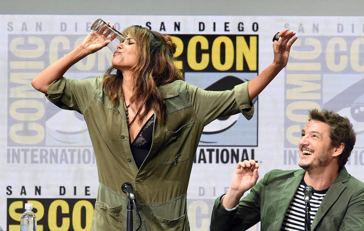 Actor Halle Berry takes a drink at a Comic-Con panel.