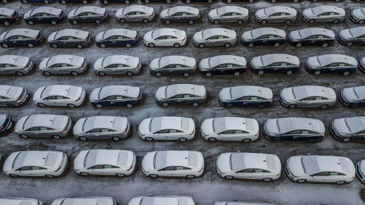 In this Dec. 5, 2018 file photo, hundreds of Chevrolet Cruze cars sit in a parking lot at a GM plant.