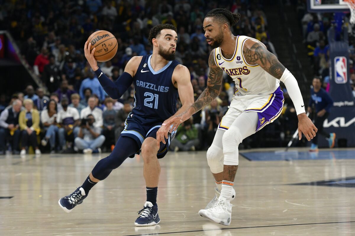 Lakers defenseman D'Angelo Russell defends Grizzlies defenseman Tyus Jones during the first game on Sunday.