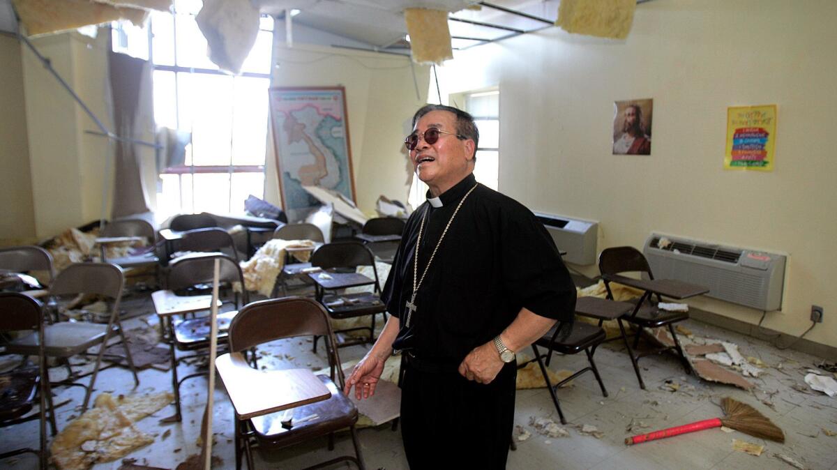 Bishop Dominic Loung returns to Mary Queen of Vietnam Church in New Orleans after it was damaged during Hurricane Katrina.