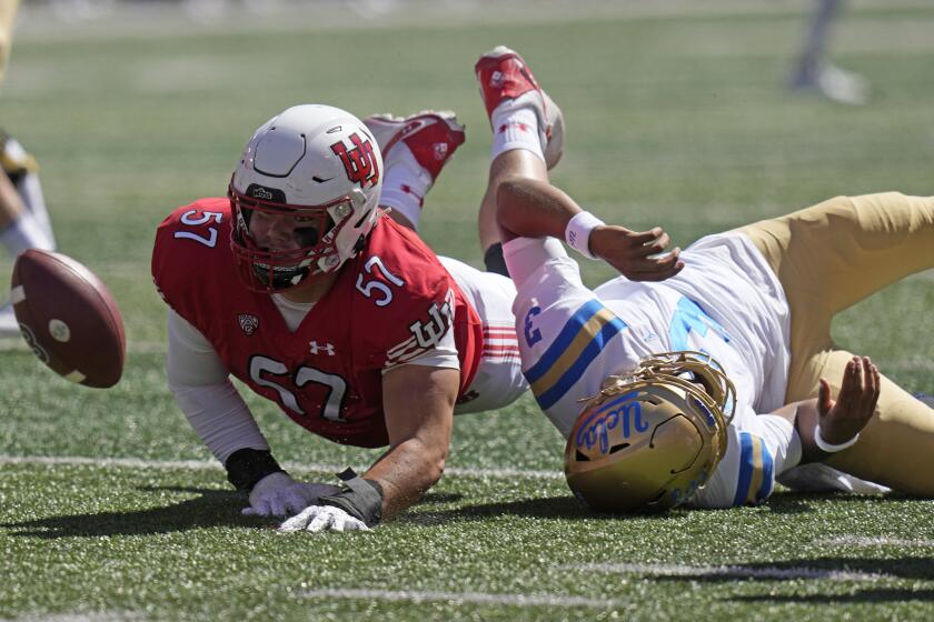 UCLA quarterback Dante Moore (3) fumbles the ball as he is hit.