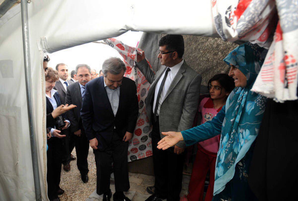 United Nations High Commissioner for Refugees Antonio Guterres, fourth from right, visits the Nizip refugee camp in Turkey on Sunday. The number of Syrian refugees, already past the 1-million mark, could double or triple by the end of the year if no solution is found to Syria's conflict, Guterres said.