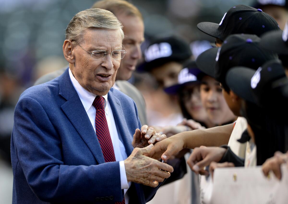 Baseball Commissioner Bud Selig shakes hands with students before a game between the Colorado Rockies and the New York Mets on May 2, 2004.