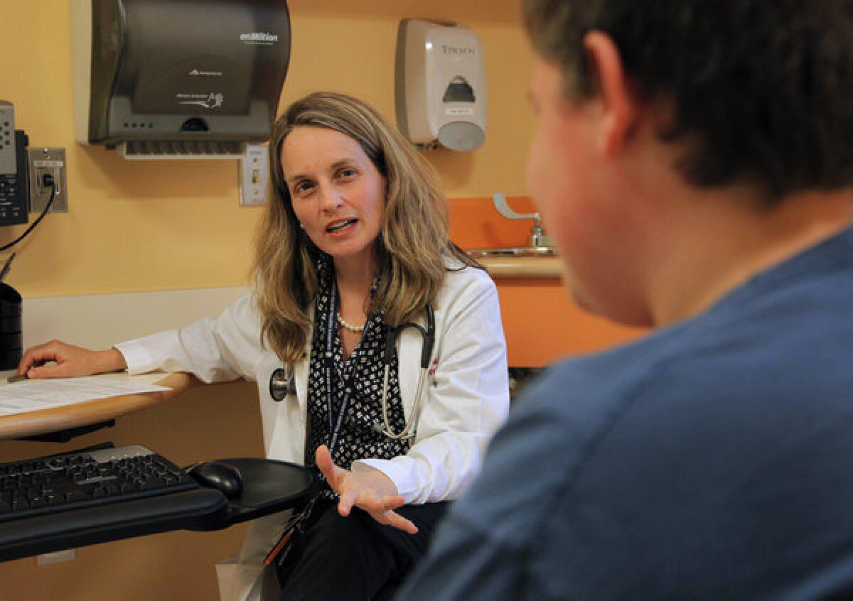 Dr. Sarah D. de Ferranti, a specialist in heart disease prevention at Boston Children's Hospital, meets with a teenage patient this week. Ferranti, writing in an editorial about new research showing that cholesterol levels in children have fallen, said the trends found in the latest study "may portend improved outcomes for the future."
