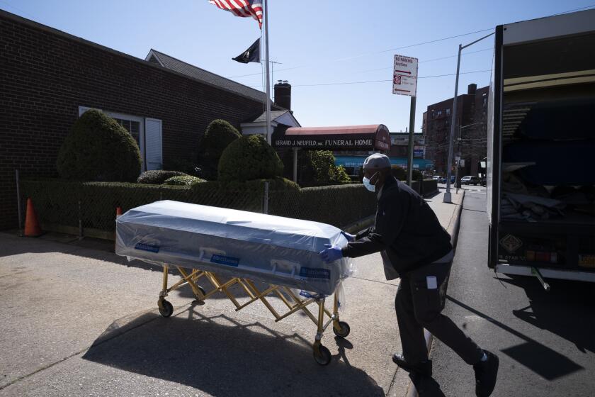 Caskets are delivered to a funeral home in Queens, New York.
